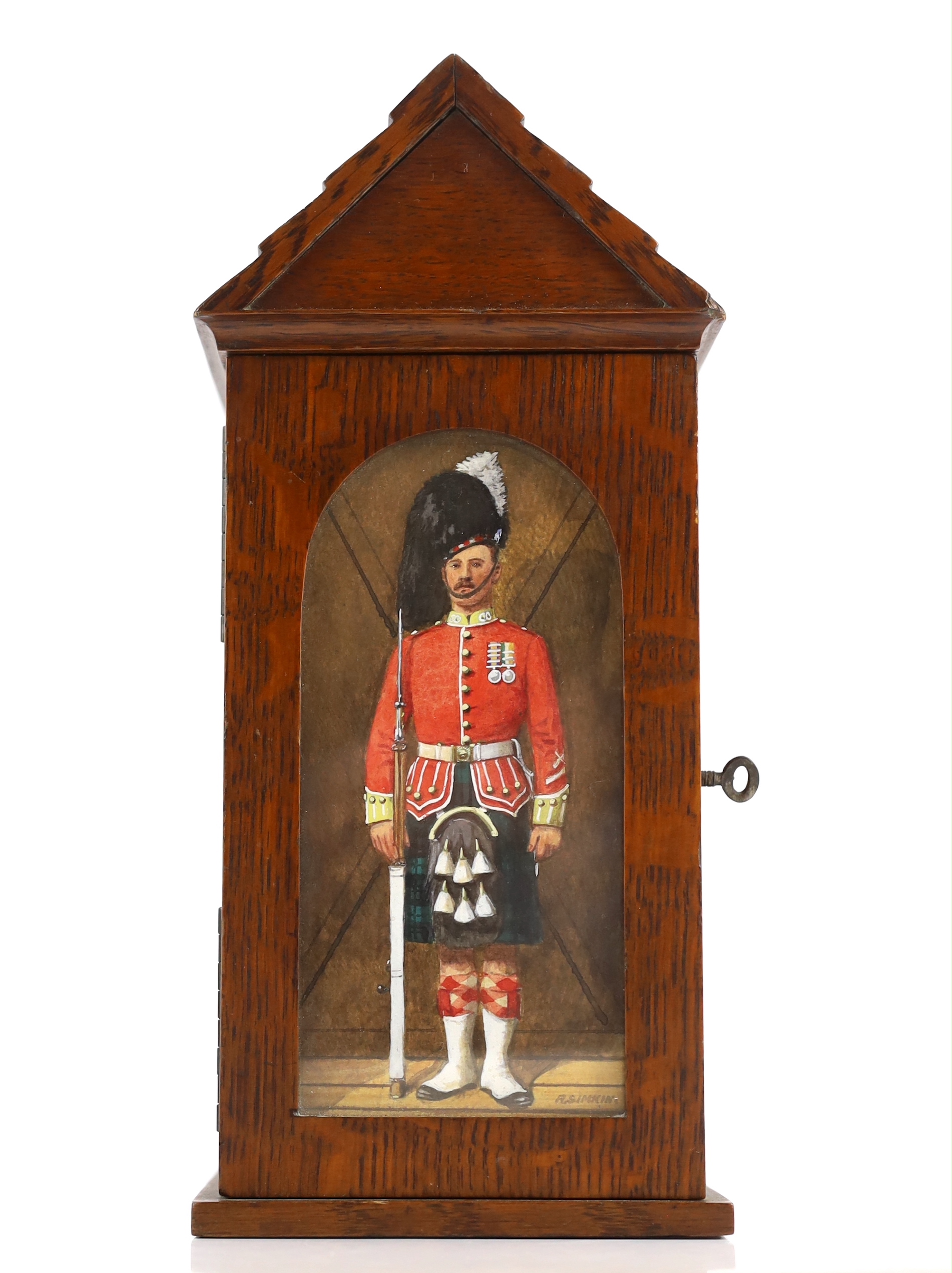 A late Victorian oak smoker’s cabinet modelled as a sentry box with a watercolour panel by Richard Simkin (1840-1926)